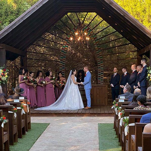 Wedding Planning Services featuring an elegant outdoor ceremony under a rustic arch in Dallas, TX
