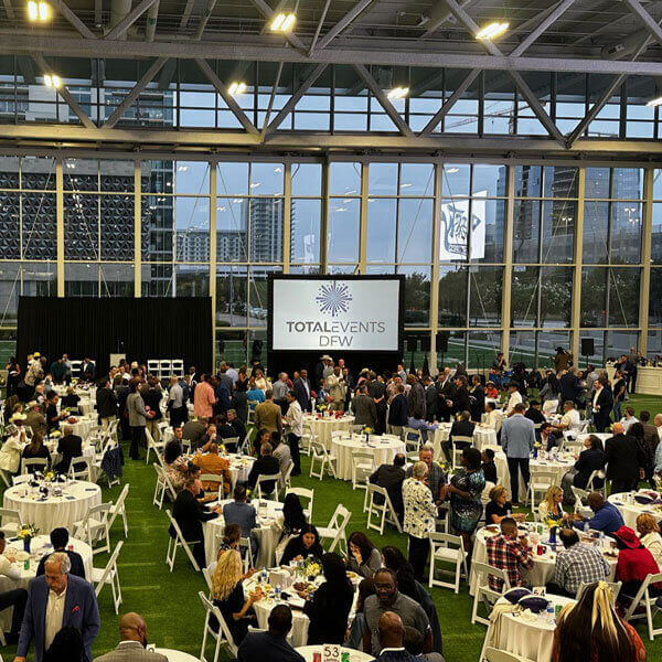 Many attendees at tables in a vast indoor area, showcasing Elevating Events in Dallas, TX